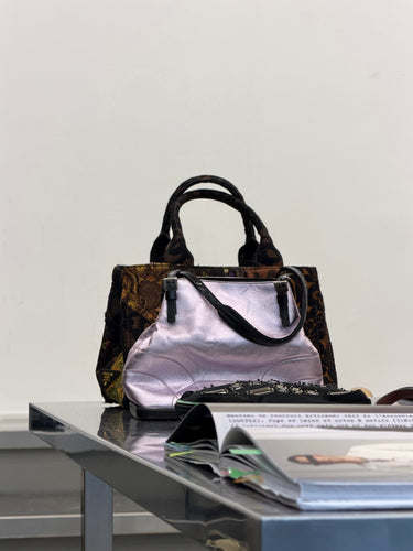 Brown handbag with handles on a reflective surface against a white background